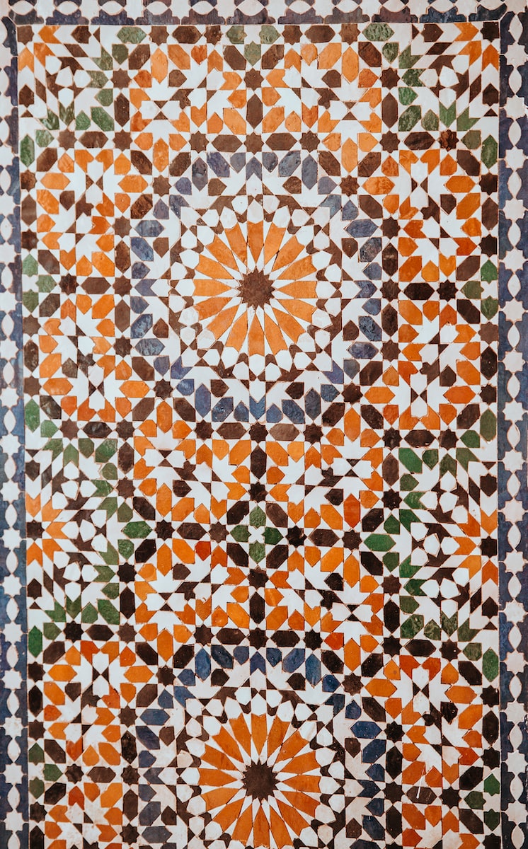 closeup photo of white, orange, and gray area rug